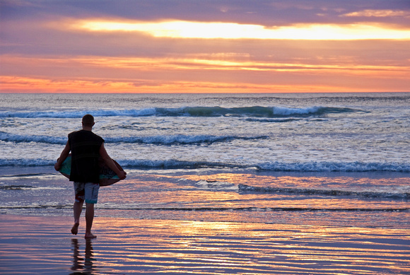 Surfboarder Watching Sunset